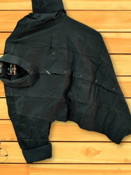 a black jacket on a wood surface